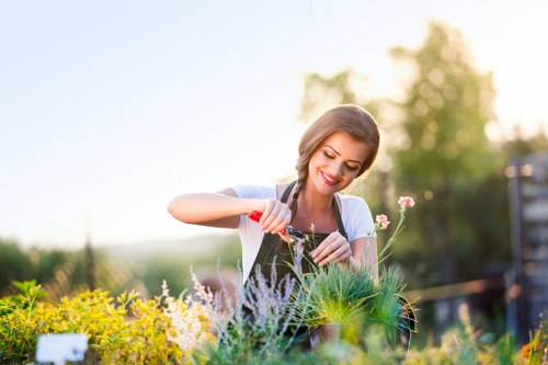 Community gardeners sorting green waste bins at a gardening center