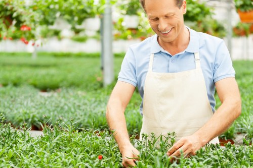 Operatives wearing PPE while working in a garden